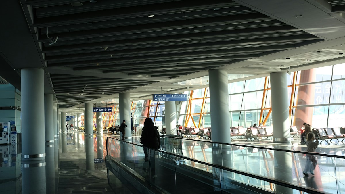 A traveler on an airport moving walkway